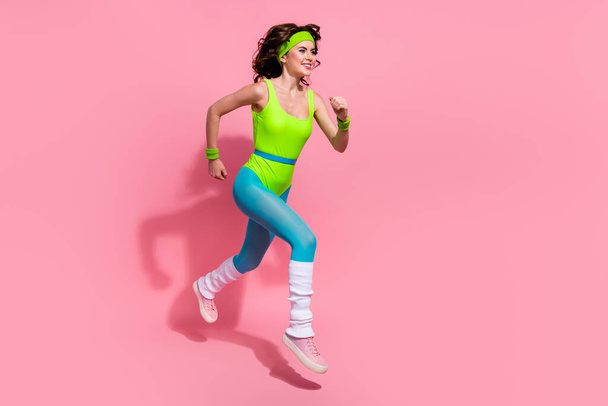 Photo of positive sporty trainer lady jump run fast prepare for sprint competition isolated on pastel color background. - Fotografie, Obrázek
