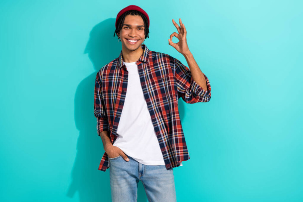 Photo portrait of handsome young man showing okey gesture toothy smile wear trendy plaid outfit isolated on aquamarine color background. - Foto, immagini