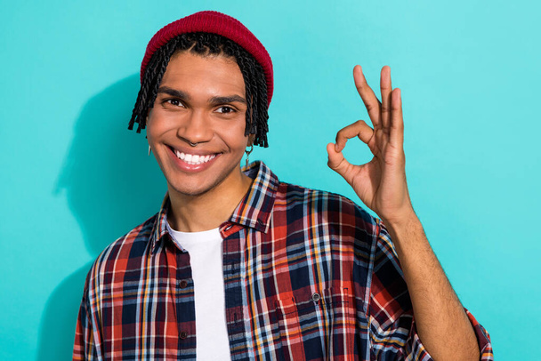 Photo portrait of attractive young male showing okey sign good quality wear trendy plaid garment isolated on aquamarine color background. - 写真・画像