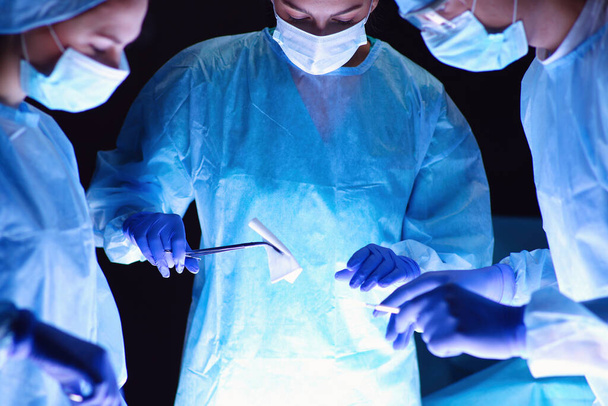 Team surgeon at work in operating. - Фото, изображение