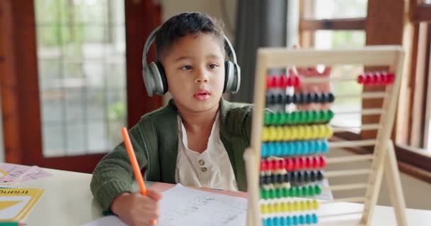 Home learning, math education or child in kindergarten studying for knowledge or growth development. Abacus, headphones or smart kid writing or counting on numbers to study for test in notebook. - Footage, Video