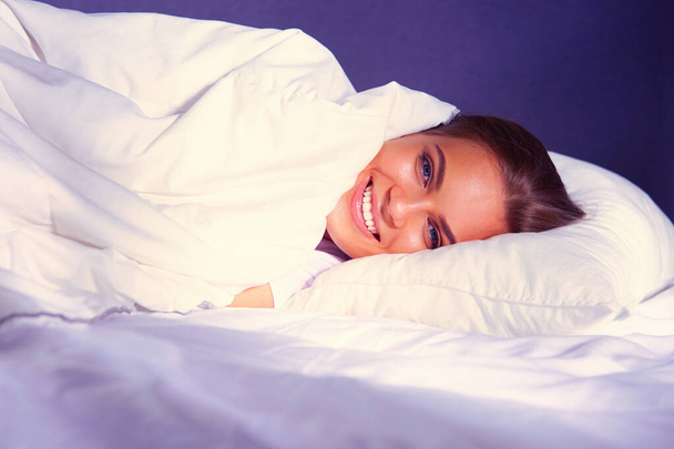 Beautiful young blonde woman sleeping in bed. - Fotó, kép