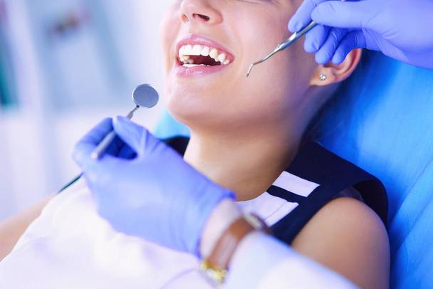 Young Female patient with open mouth examining dental inspection at dentist office - Photo, image