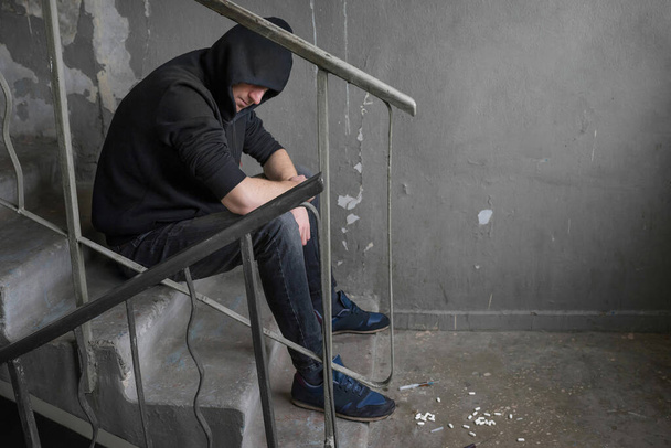 Addict in an abandoned house, experiencing a drug addiction crisis. Addiction concept. - Φωτογραφία, εικόνα