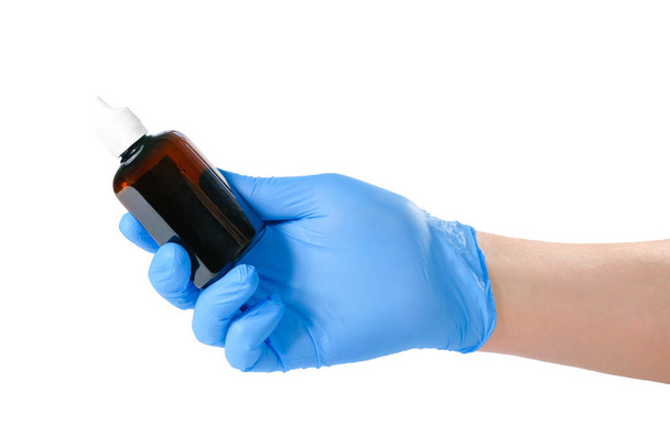 A hand in a blue medical glove holds a bottle of vaccine or medicine, isolated on white background. Health concept. - Φωτογραφία, εικόνα