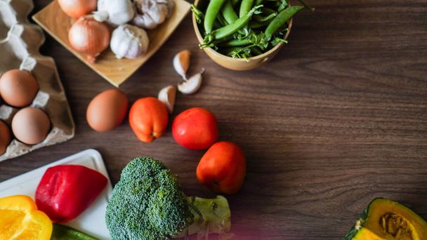 Flay lay food cooking vegetable broccoli egg pepper pea garlic background on wood texture text copy space - 写真・画像