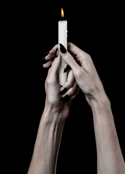 hands holding a candle, a candle is lit, black background, solitude, warmth, in the dark, Hands death, hands witch - Foto, afbeelding