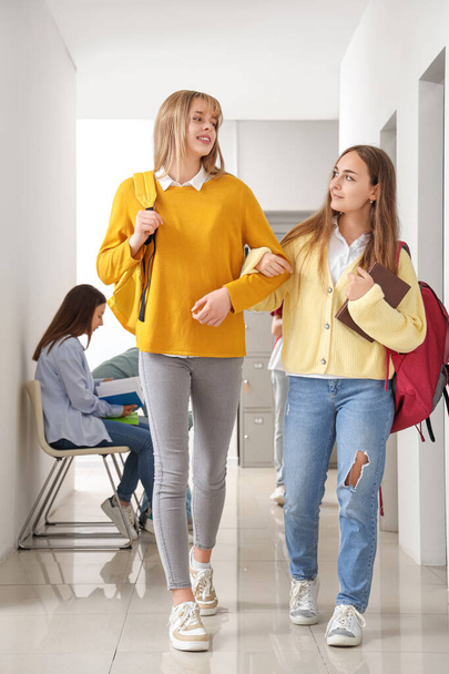 Teenage girls walking at school - Foto, afbeelding