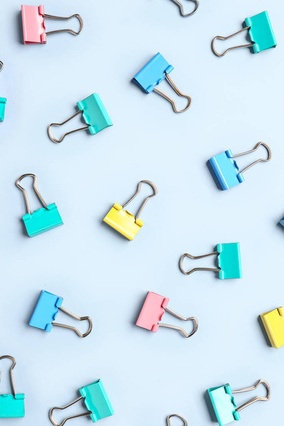 Colorful binder clips on light blue background - Photo, Image