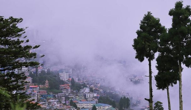 panoramic view of misty and cloudy darjeeling hill station and himalaya mountain foothills in monsoon season, west bengal in india - Photo, Image
