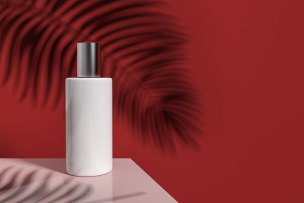 View of white blank plastic jar with cosmetic product and silver cap standing on pink table over red background with leaf shadow and copy space. Beauty and skincare concept. 3d rendering - 写真・画像