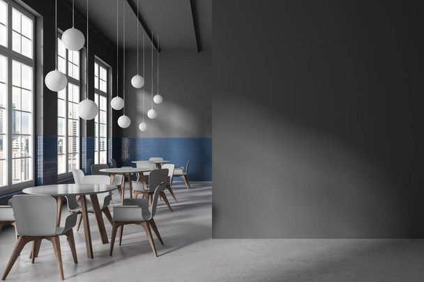 Grey cafe interior with grey chairs and round table on grey concrete floor. Stylish dining and meeting space with panoramic window on Kuala Lumpur. Mock up empty wall partition. 3D rendering - Foto, Imagem