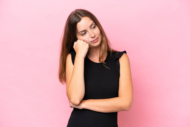 Young caucasian woman isolated on pink background with tired and bored expression - Φωτογραφία, εικόνα