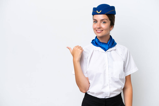 Airplane stewardess caucasian woman isolated on white background pointing to the side to present a product - Photo, Image