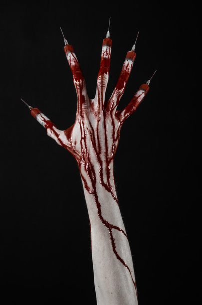 Bloody hand with syringe on the fingers, toes syringes, hand syringes, horrible bloody hand, halloween theme, zombie doctor, black background, isolated - Zdjęcie, obraz