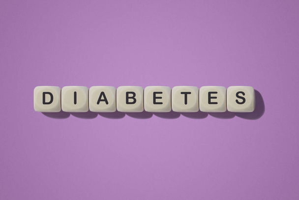 Diabetes inscription. On wooden cubes. On a pink background. - Photo, Image