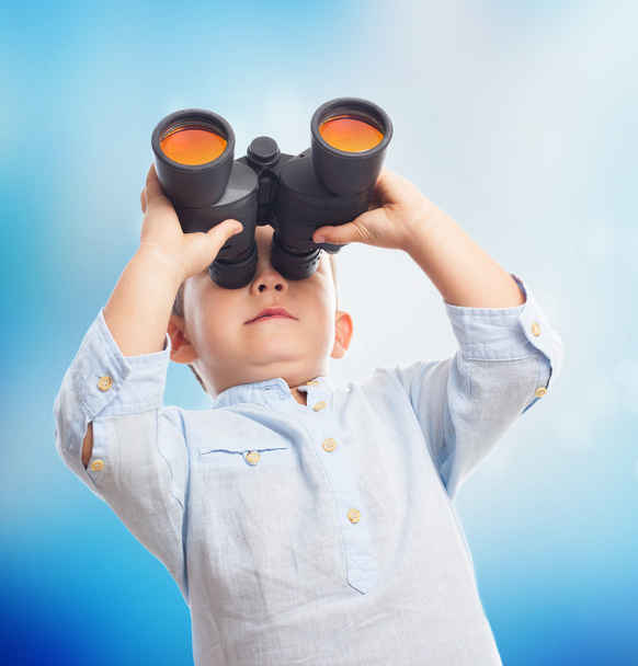 Boy looking through the binoculars - Photo, Image