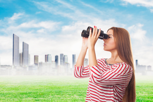 Woman looking through the binoculars - Photo, Image