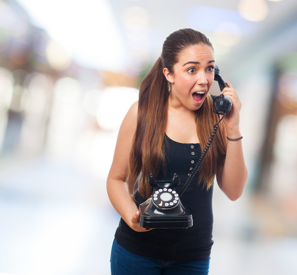 Woman surprised talking on telephone - Foto, immagini