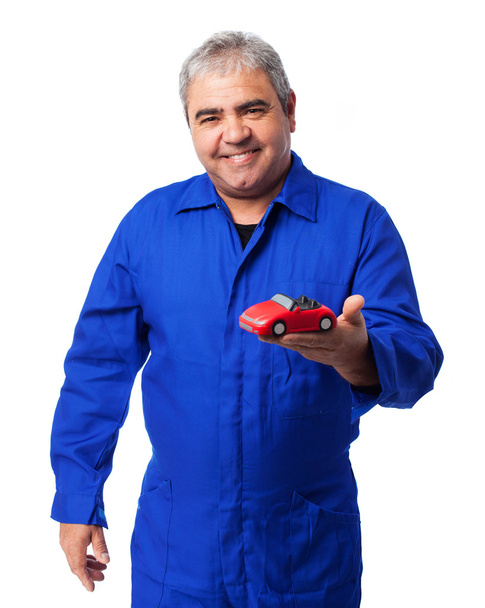 Mechanic holding car toy - Photo, Image