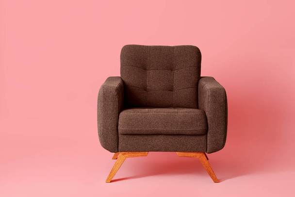 Brown armchair on pink background - Foto, Imagen