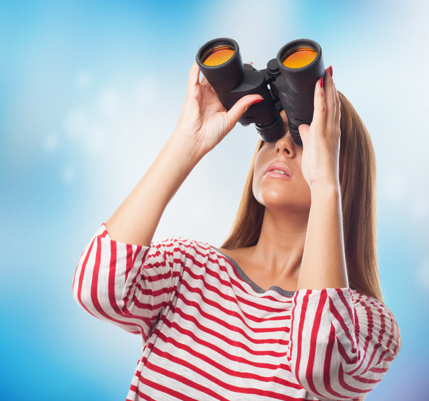 Woman looking throught a binoculars - Photo, Image