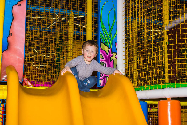 The little boy playing at children's entertainment center or abstract playroom or playground - Foto, Imagem