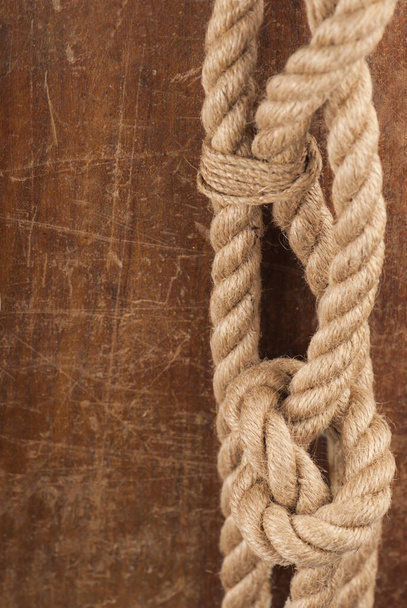 Old rope on a brown wooden. Vintage background with empty space for text - Φωτογραφία, εικόνα