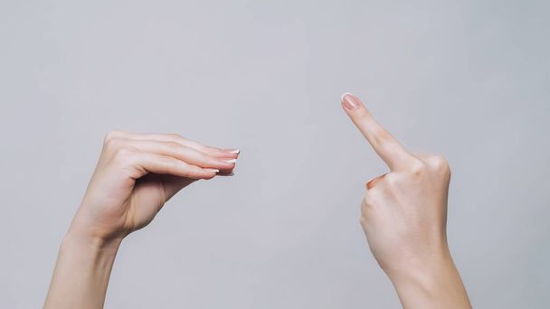 Blah gesture. Middle finger. Woman hands arguing showing fuck off quarrel demonstrating aggressive sign isolated on gray free space background. - Φωτογραφία, εικόνα