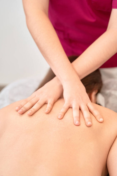  Anonymous Physical Therapist Administers Treatment on Patients Back - Valokuva, kuva