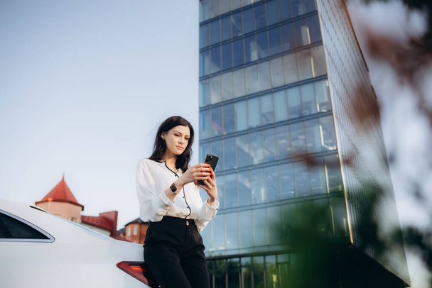 Profesionální žena manažer s tablet stojí poblíž auto na kancelářská budova. - Fotografie, Obrázek
