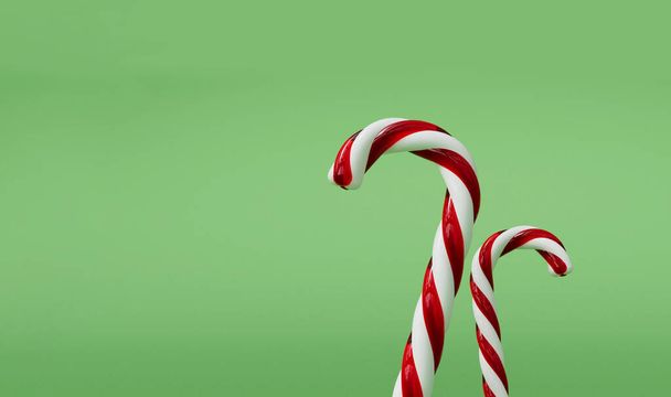 Christmas candy cane red and white festive sweet on a green background. 3D Rendering - Foto, Imagem
