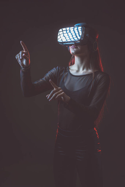 Beautiful active young attractive caucasian fit model woman uses hi tech futuristic Vr glassess for augmented reality. Photo of sportive beauty brunette sportswoman attractive white model. - Fotografie, Obrázek