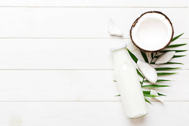 coconut products on white wooden table background. Dairy free milk substitute drink, Flat lay healthy eating. - Foto, immagini
