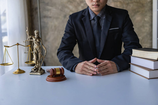 lawyer, modern office, in formal attire. Golden scales law book, working on real estate and contract documents. Arguments for a defensive strategy fight for freedom - Photo, Image
