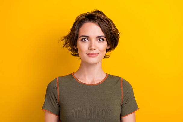 Photo of cheerful positive cute pretty woman with bob hairstyle wear trendy t-shirt look at camera isolated on yellow color background. - Φωτογραφία, εικόνα