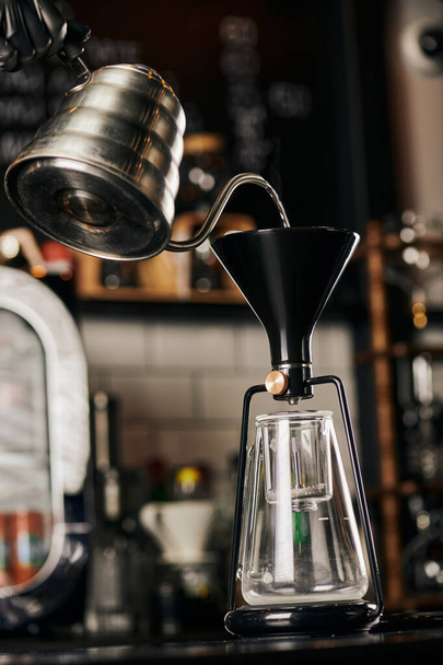 osittainen näkymä barista kaatamalla kiehuvaa vettä koottu sifonki kahvinkeitin kahvilassa - Valokuva, kuva