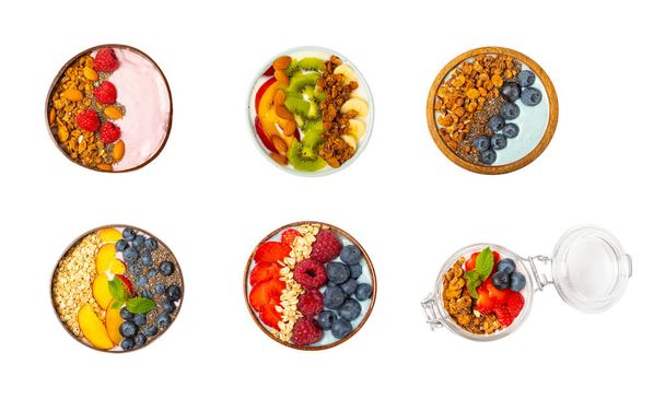 Bowl of granola with yogurt and fresh almonds, blueberries, raspberries,peach and strawberries isolated on white background. Healthy food. balanced breakfast. - Foto, Bild
