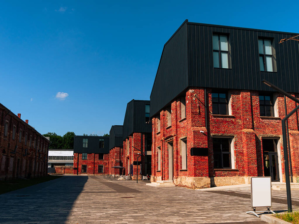 Modern cafe workspace exterior loft style red brick wall Old industrial building renovation. Creative urban space Break-out area city loft conversion brickwork warehouse design floor-to-ceiling window - Photo, Image