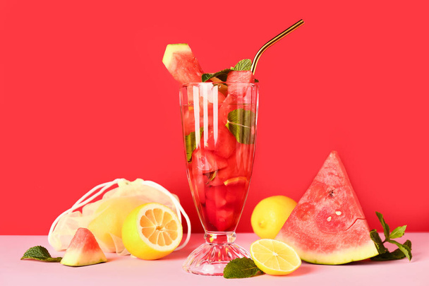 Glass of fresh watermelon lemonade with mint on pink table - Photo, Image