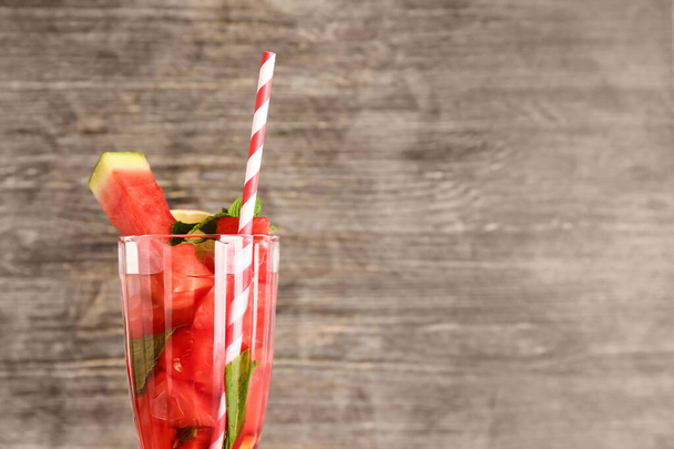 Glass of fresh watermelon lemonade with mint on wooden background - Photo, Image
