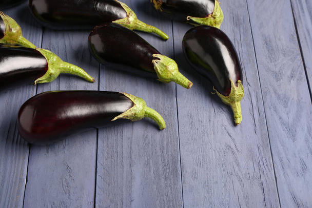 Fresh eggplants on blue wooden background - Foto, imagen