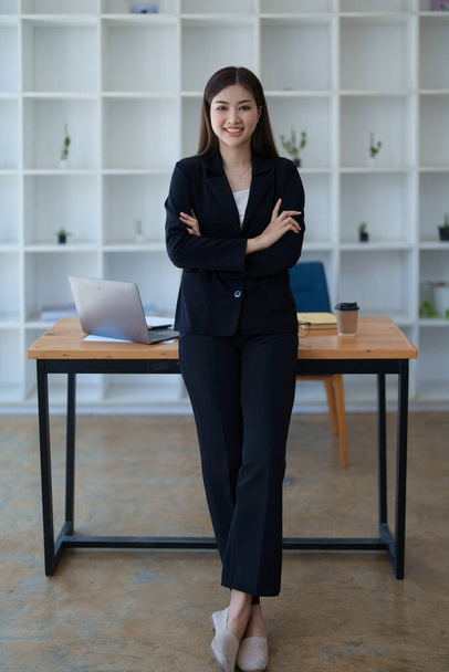 Negocios, finanzas y empleo, concepto de emprendedoras exitosas. Confiado sonriendo asiático mujer de negocios, utilizando el ordenador portátil en el trabajo - Foto, imagen