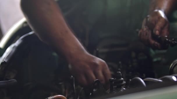 Bolts Removed from Old Car Engine in Repair Shop Footage. - Video