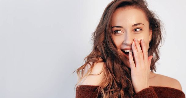 Pleasant surprise. Beauty novelty. Shock gesture. Amazed pretty woman with nude makeup hand to open mouth isolated on white empty space background. - Foto, afbeelding