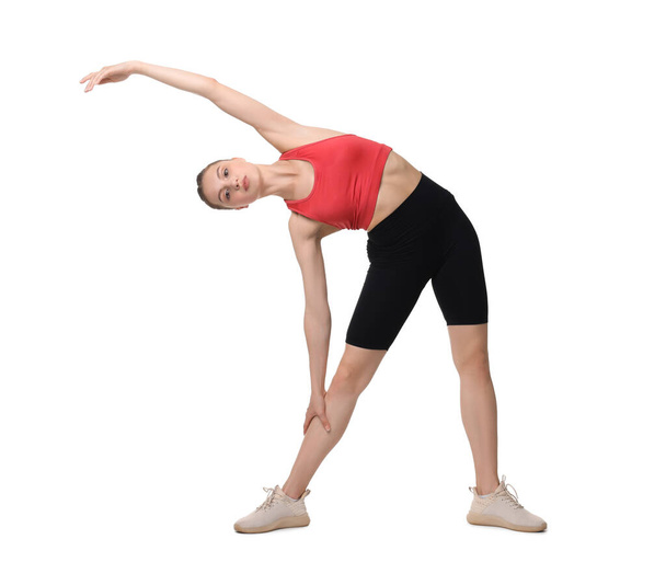 Yoga workout. Young woman stretching on white background - Photo, Image