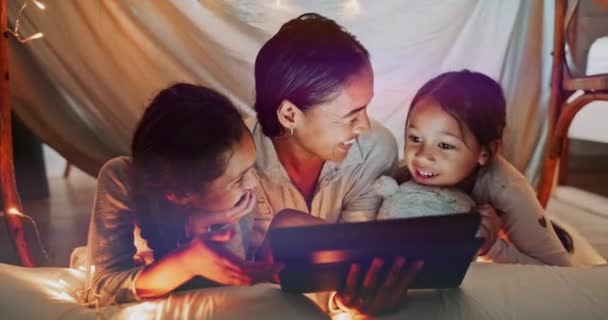 Children, tablet and mother with her girls in a bedroom tent together, reading a story online or browsing social media. Kids, technology and funny with a family laughing at a meme or internet joke. - Materiał filmowy, wideo