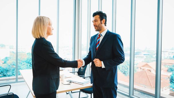 Business people handshake in corporate office showing professional agreement on a financial deal contract. Jivy - Foto, imagen