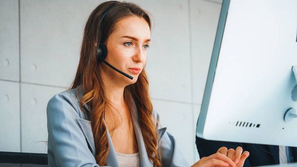 Business people wearing headset working in office to support remote customer or colleague. Call center, telemarketing, customer support agent provide service on telephone video conference call. Jivy - Fotoğraf, Görsel