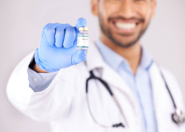 Vaccine, doctor hands and monkeypox bottle for safety, medicine development and healthcare innovation in studio. Closeup of medical worker with vaccination, liquid vial and drugs for virus immunity. - Foto, Imagen